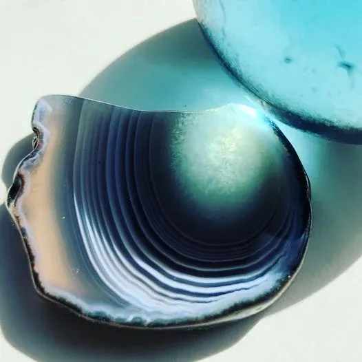A slice of blue agate with curved bands like rings.