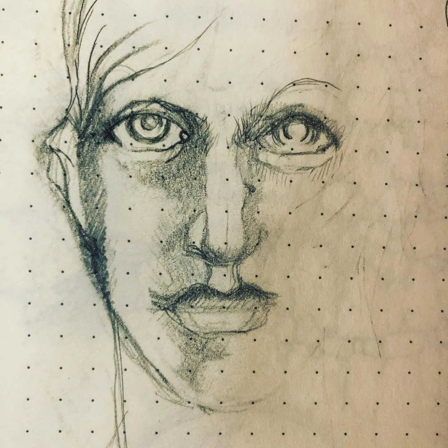 Pencil portrait of a face looking straight out with wide eyes and heavy smudged shading down one side.