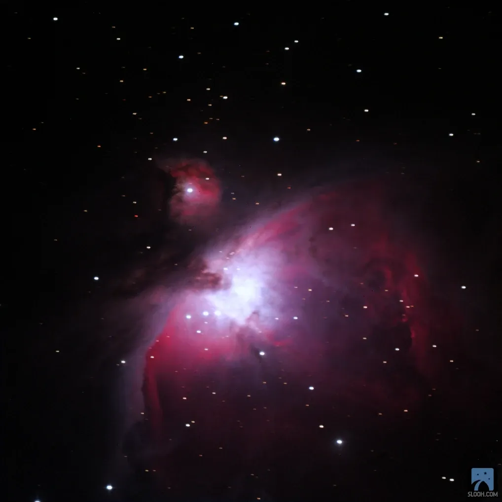 The Orion Nebula (M42), a bright cloud of pink, red and purple gas.