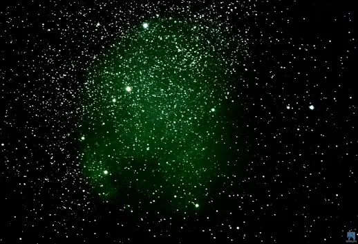 The North America Nebula (NGC 7000), a faint green-tinted cloud in a dense field of stars.