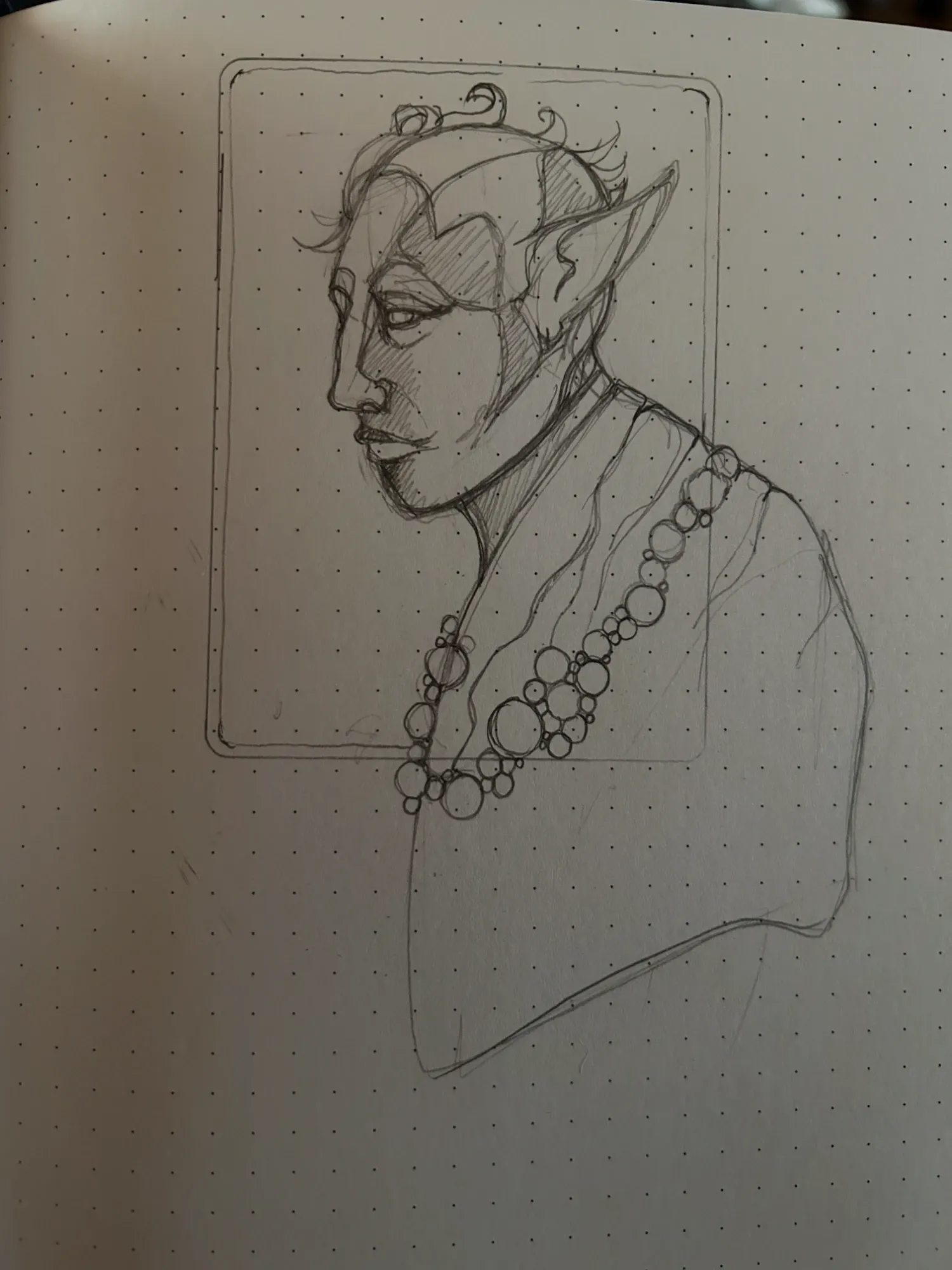 The first pencil sketch of the same elf on the dotted page of a Moleskine.