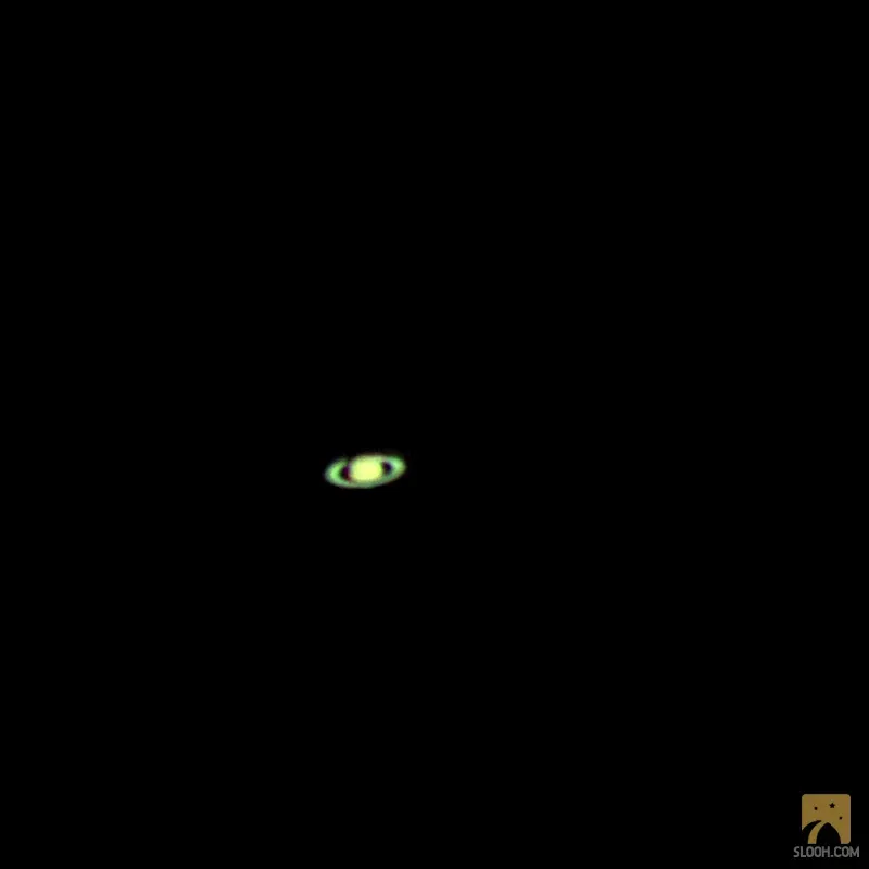 Saturn, a small ringed point of light on a black sky.